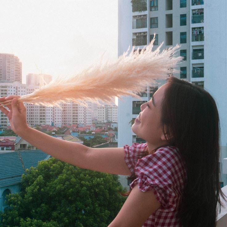 Kaveri Mehta, Lead Design Curator at Garden Harbor Book, reviewing corporate floral arrangements